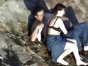 Older couple fucking on the rocky beach
