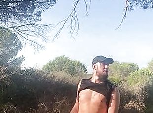 Hot bearded guy jerking off in the woods.