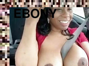 Solo ebony Desiree Desire shows her tits while driving