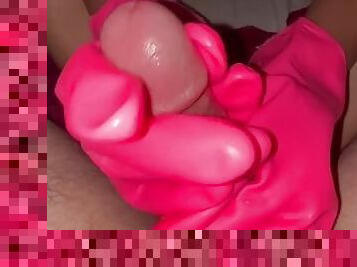 Handjob with pink rubber gloves with feet teasing dick