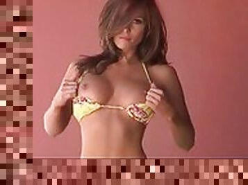 Beautiful brunette in a bikini shows off her titties