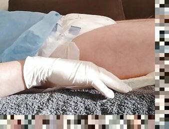 Urinating in a diaper with an inserted catheter after filling the bladder, relaxing...