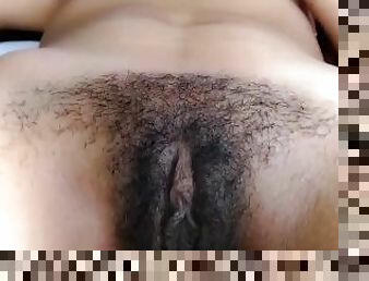 Latina shows her hairy pussy close to the camera
