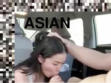 Sex of an Asian woman with big tits in a public car on the first date