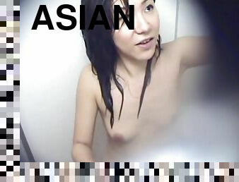 Two Asian Women in a Cramped Bathroom
