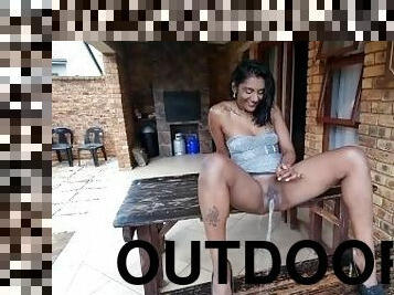 Pissing outdoors while sitting on a wooden table  table piss  pulled up silver dress