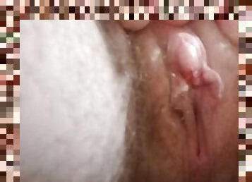 Close-up of pussy and large clit while pissing