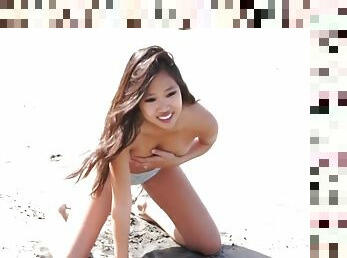 Hot Asian model Audrey in yellow bikini strips on beach