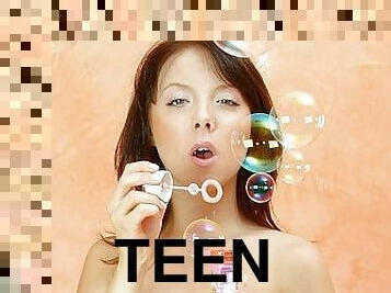teen plays with soap bubbles