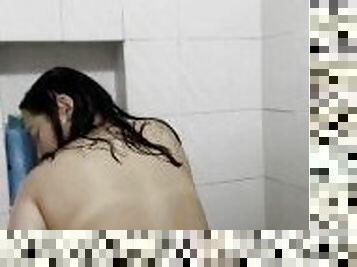 Joven latina dándose placer mientras se baña