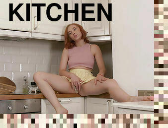 Redhead babe Little Elizabeth fucks her pussy in the kitchen