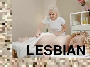 Lesbian blonde masseuse fucks her client with a strap-on dildo