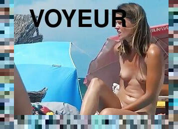 Naked woman does not know that she is being filmed by a voyeur