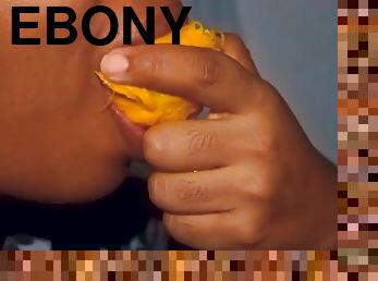 Sexy ebony mouth playing with a mango