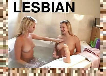 Cute striped lesbian with dildo in the bath