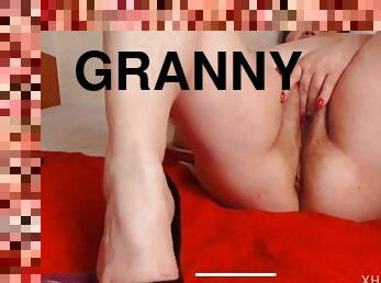 Elegant granny with saggy tits shows her ass and pussy during masturbation