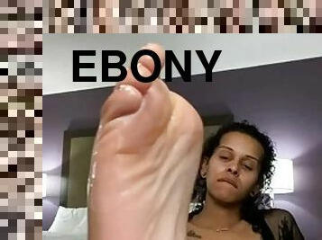 Cute ebony takes off her heels and shows off her pretty feet