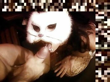 Dressing up as a sexy kitty the horny brunette goes down on a large cock