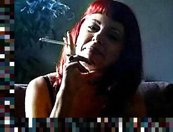 Mature redhead smokes and slowly strips