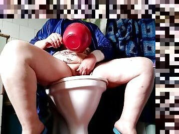 mother-in-law as she pisses in the toilet while standing and washes her cunt