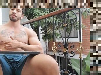 flexing in balcony in shorts showing muscles