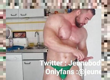 bodybuilder with oiled body jerks off and flexes