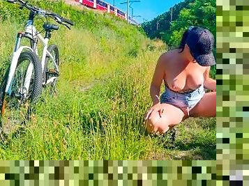 Woman pissing in public while cycling