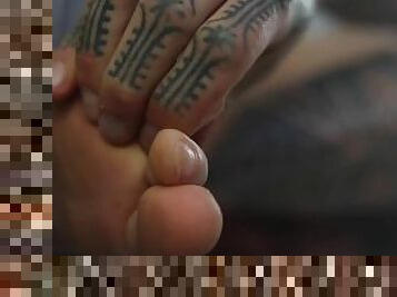 Feet worship with tattooed hands