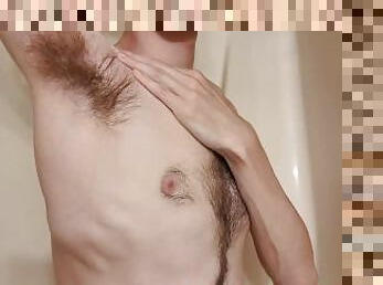 Tall boy playing with his hairy armpits in the shower