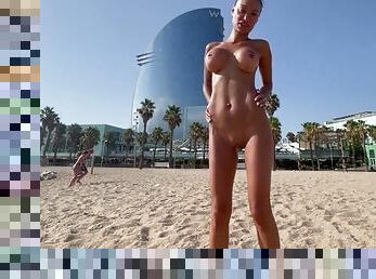 Naked Monika Fox swims in the sea and walks along the beach on a public beach