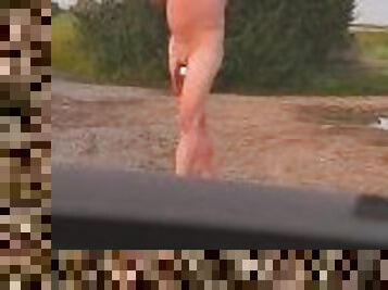 Barefoot nude at side of highway