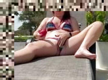 Redhead MILF masturbating by the pool