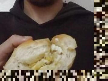 Eating a bread with egg on it