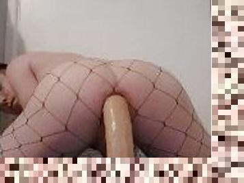 Femboy takes huge dildo in fishnets